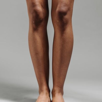 Person holding a stable balancing pose against a neutral background.